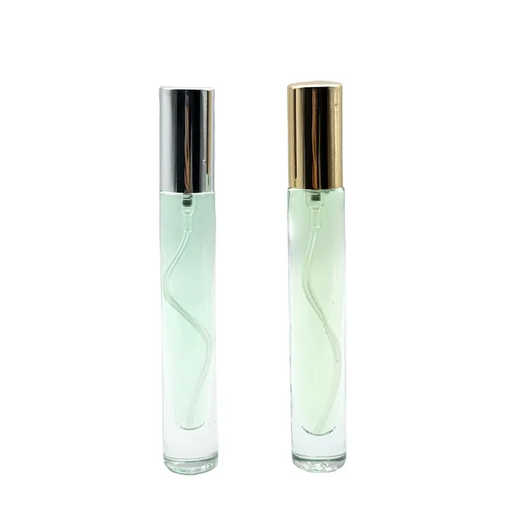 Two green cylindrical perfume atomizers with black and gold caps