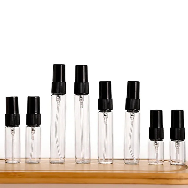 Small cylindrical perfume sample spray bottles in rows