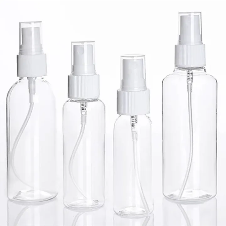 Four clear plastic atomizers with white spray heads