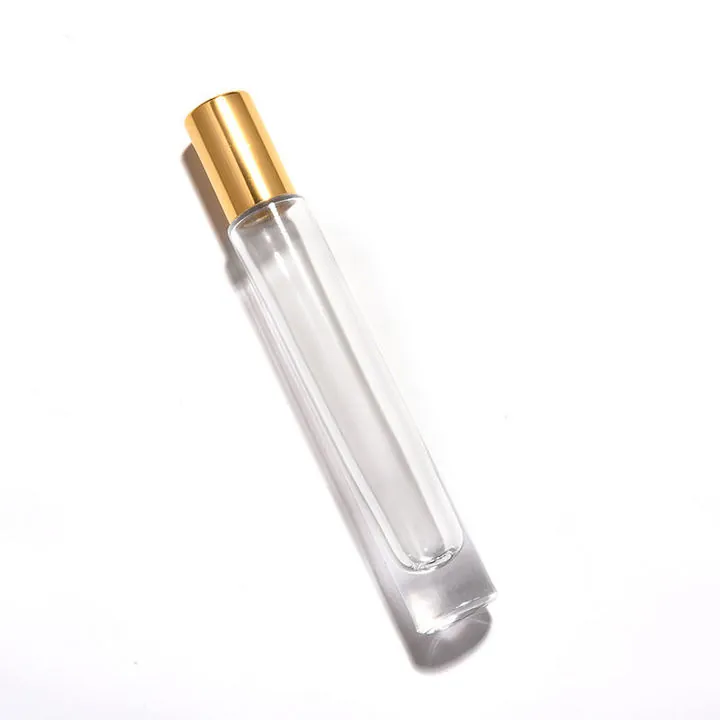 Frasco de perfume esbelto y transparente con tapón dorado
