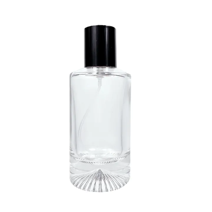 Frasco de perfume cilíndrico transparente con base en forma de rayos de sol y tapón negro