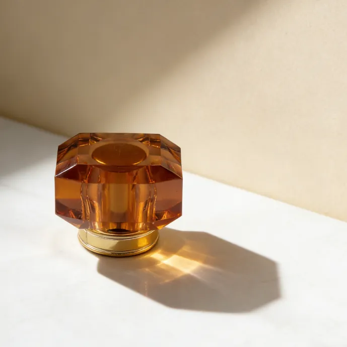 Amber transparent faceted perfume bottle cap displayed clearly
