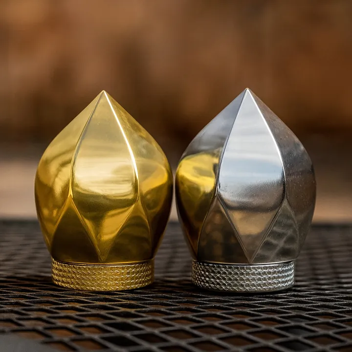 Gold and silver faceted perfume bottle caps displayed together