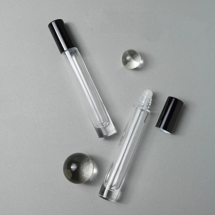Two slim roll-on perfume oil bottles with black caps