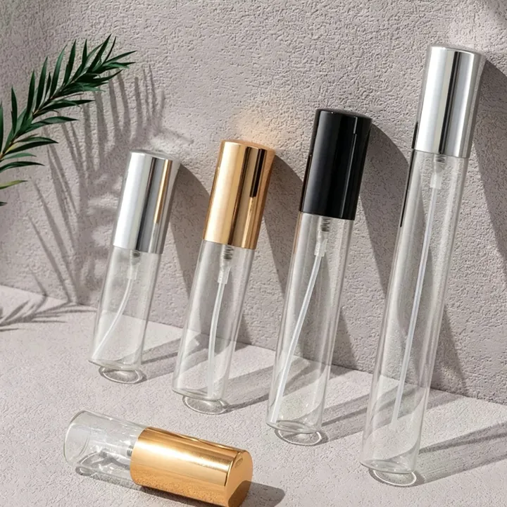 Clear cylindrical perfume sample spray bottles with gold silver and black sprayers