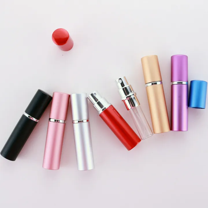 Multiple colorful aluminum portable perfume bottles in assorted finishes