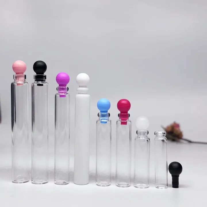 Clear perfume sample bottles with colorful rollerball caps and different bottle shapes