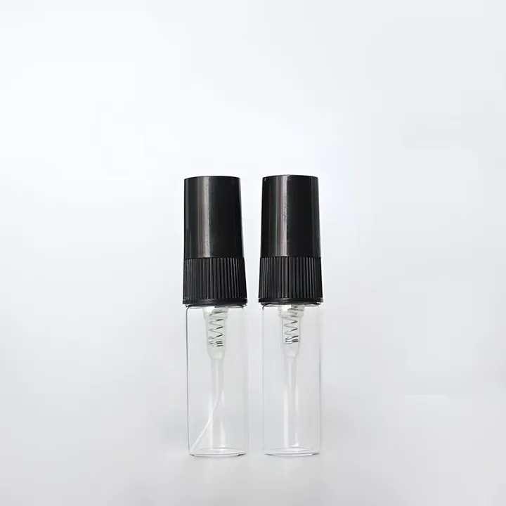 Two clear perfume sample vials with black spray pumps