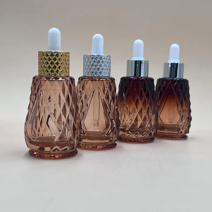 Amber faceted serum dropper bottles with gold and silver caps