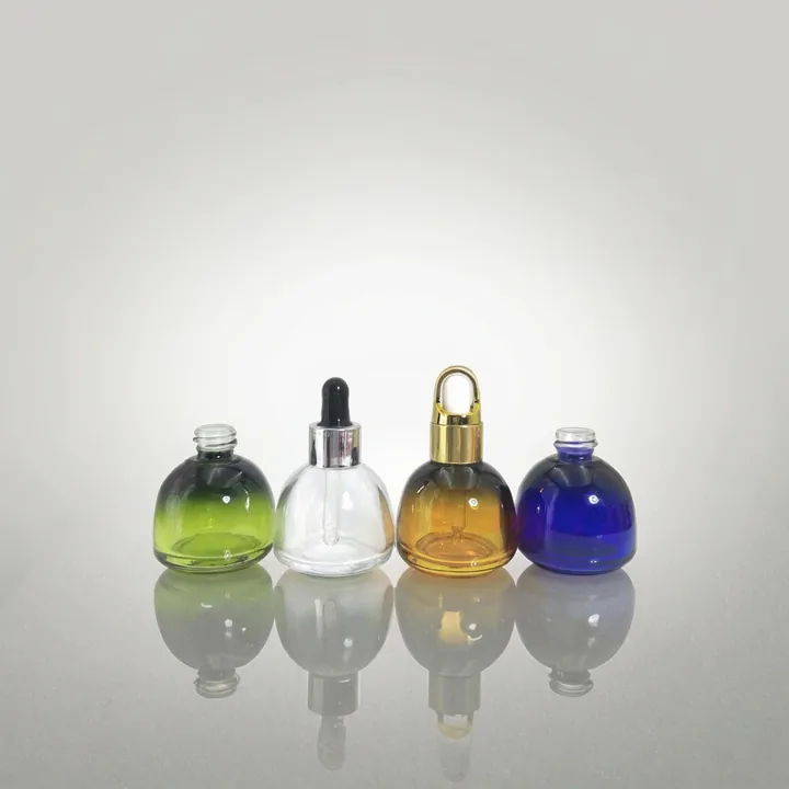 Round serum bottles in green, clear, amber and blue colors