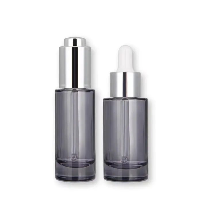 Smoke gray cylindrical serum bottle with silver dropper caps