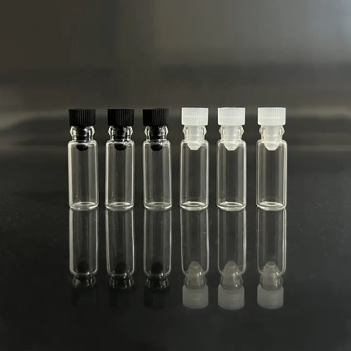 Small clear glass sample vials with black and white plastic stoppers