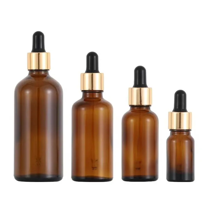 Amber dropper bottles with gold caps arranged in multiple capacities