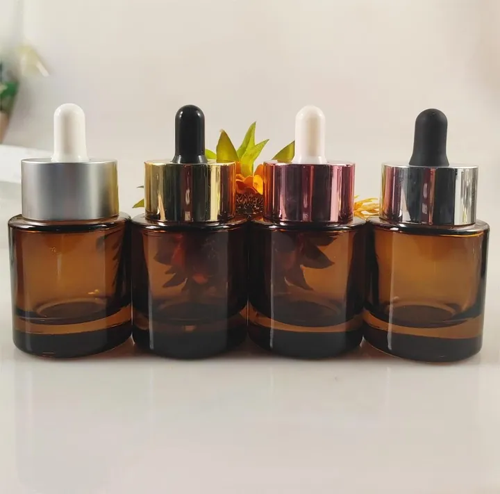 Wide amber glass dropper bottles on tabletop