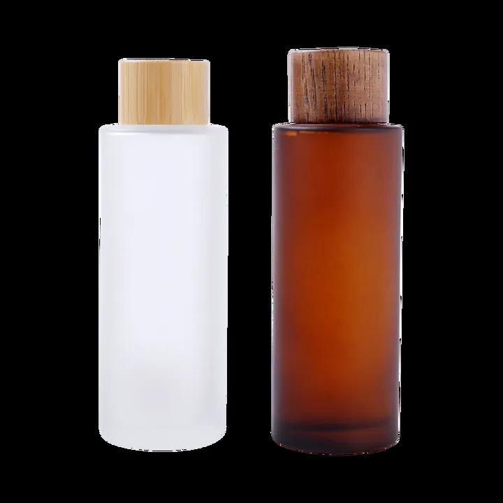 White and amber frosted glass toner bottles with wood caps
