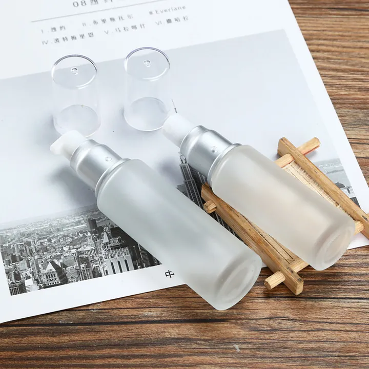 Two frosted glass lotion pump bottles displayed on a tabletop