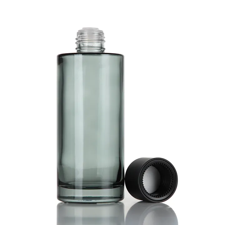 Single green transparent thick-bottom glass toner bottle with black cap