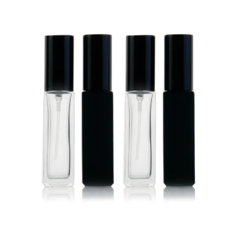 Four slim clear and black glass spray bottles displayed together