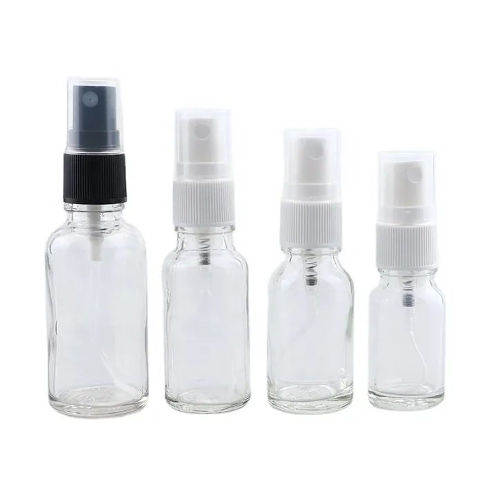 Four clear glass fine mist spray bottles in different capacities