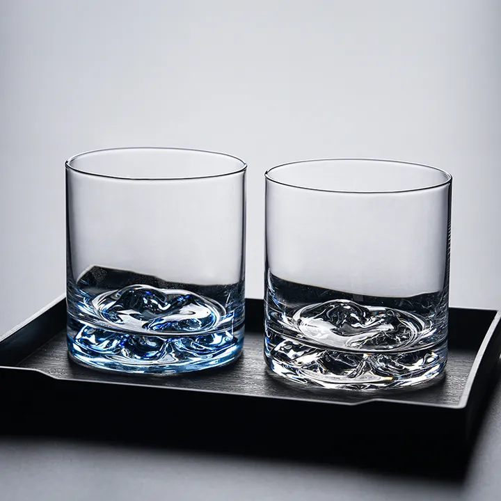 Two mountain base whiskey glasses displayed on a tray