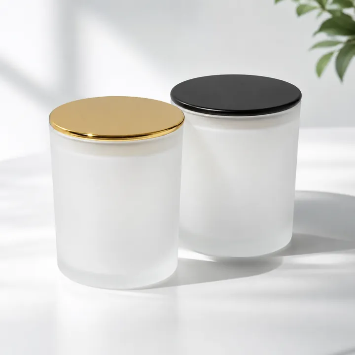 White frosted glass candle jars with gold and black metal lids