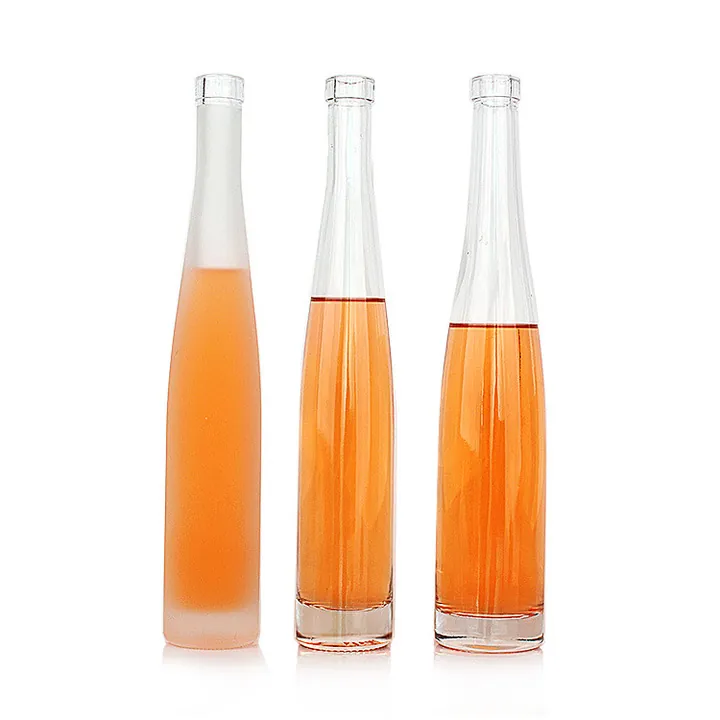 Three slim glass bottles with one frosted colored bottle