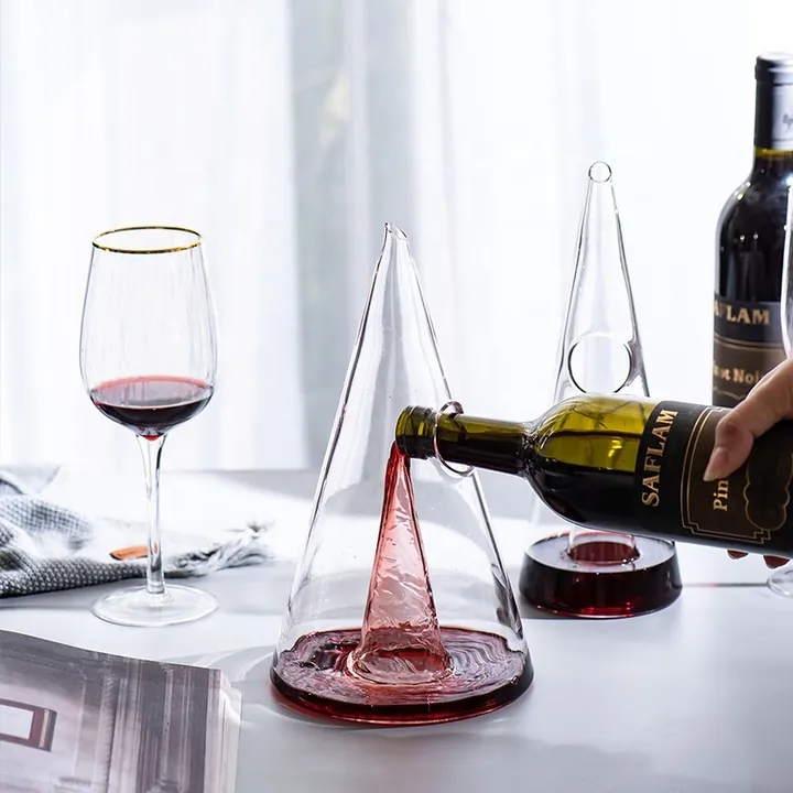 Pyramid shaped glass decanter with wine glass and bottle