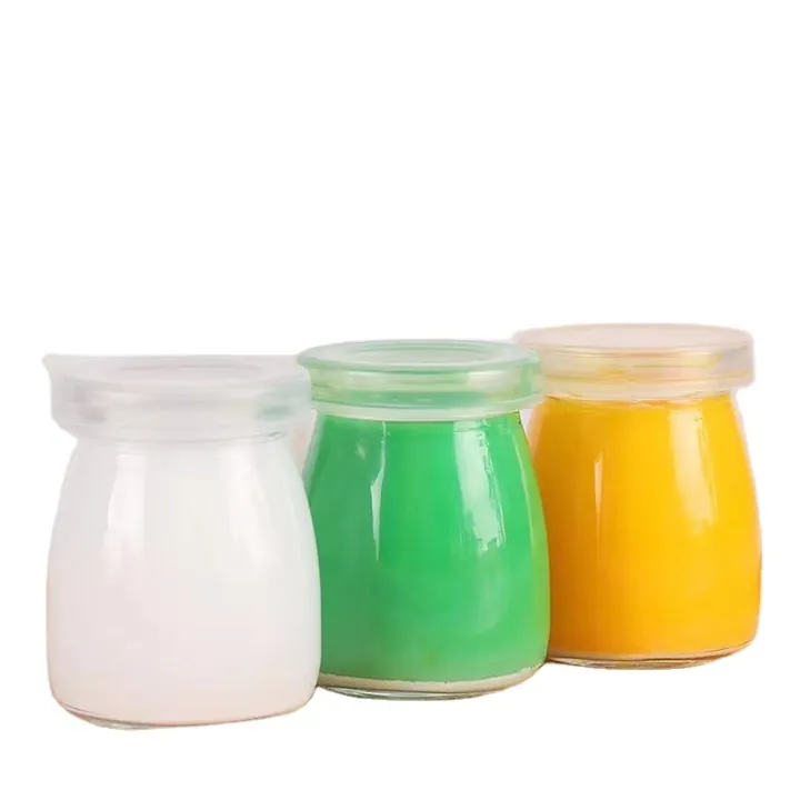 Three round yoghurt glass jars with white green and yellow contents