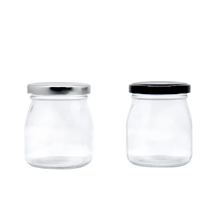 Two empty yoghurt glass jars with silver and black metal lids