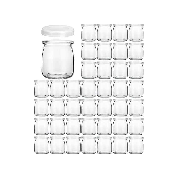 Clear glass yogurt jars arranged in rows with white plastic lids